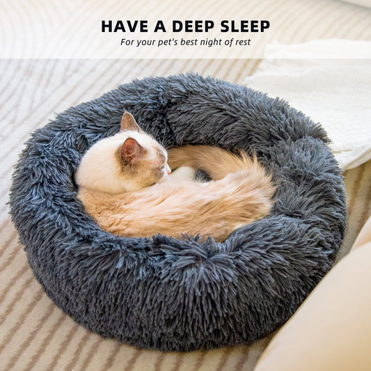 "Ultra-soft, fluffy pet bed designed for deep sleep and relaxation. Features a plush, round donut shape with cozy faux fur for warmth and comfort. Ideal for cats and small dogs to curl up and enjoy a restful sleep."