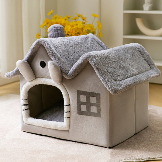 "Soft and cozy plush pet house designed like a charming gray cottage, featuring a warm fleece interior, cushioned roof, and an open doorway for easy access. Ideal for cats and small dogs, offering comfort, warmth, and a secure resting spot."