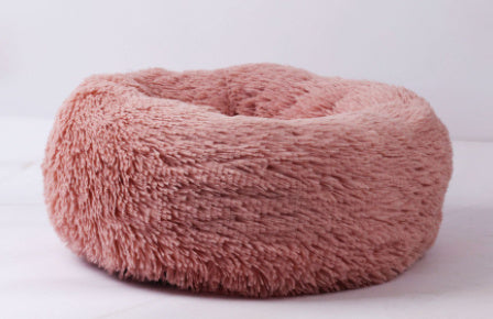 "Ultra-soft, fluffy pet bed designed for deep sleep and relaxation. Features a plush, round donut shape with cozy faux fur for warmth and comfort. Ideal for cats and small dogs to curl up and enjoy a restful sleep."