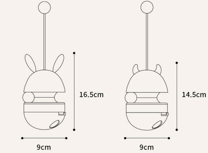 "Bunny-shaped interactive pet food tumbler with a wobbling base, treat dispenser, and playful stick with a yellow ball. Engages pets with fun and stimulating play."