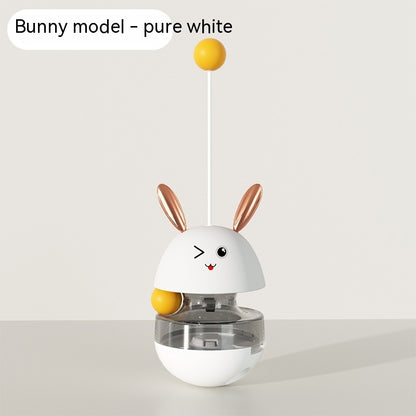 "Bunny-shaped interactive pet food tumbler with a wobbling base, treat dispenser, and playful stick with a yellow ball. Engages pets with fun and stimulating play."