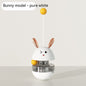 "Bunny-shaped interactive pet food tumbler with a wobbling base, treat dispenser, and playful stick with a yellow ball. Engages pets with fun and stimulating play."