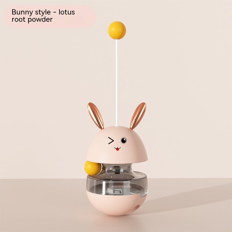 "Bunny-shaped interactive pet food tumbler with a wobbling base, treat dispenser, and playful stick with a yellow ball. Engages pets with fun and stimulating play."